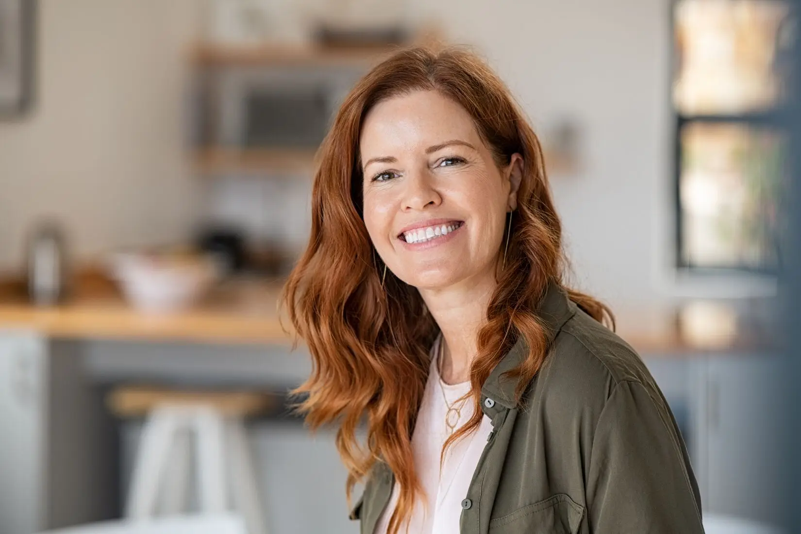 A smiling woman with red hair