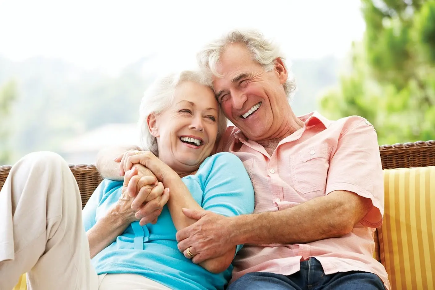 An older couple laughing together at home