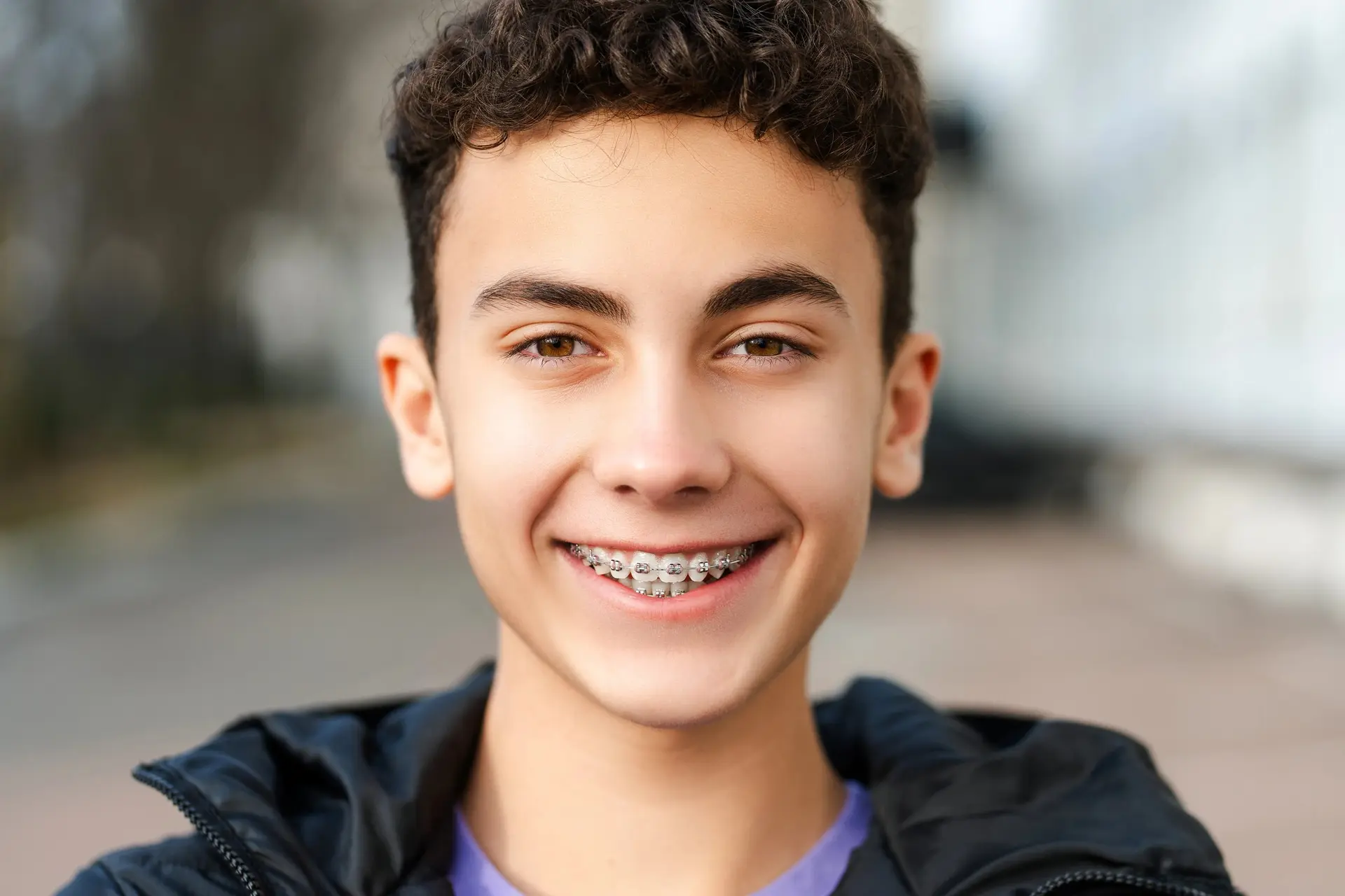 A smiling teenager wearing braces